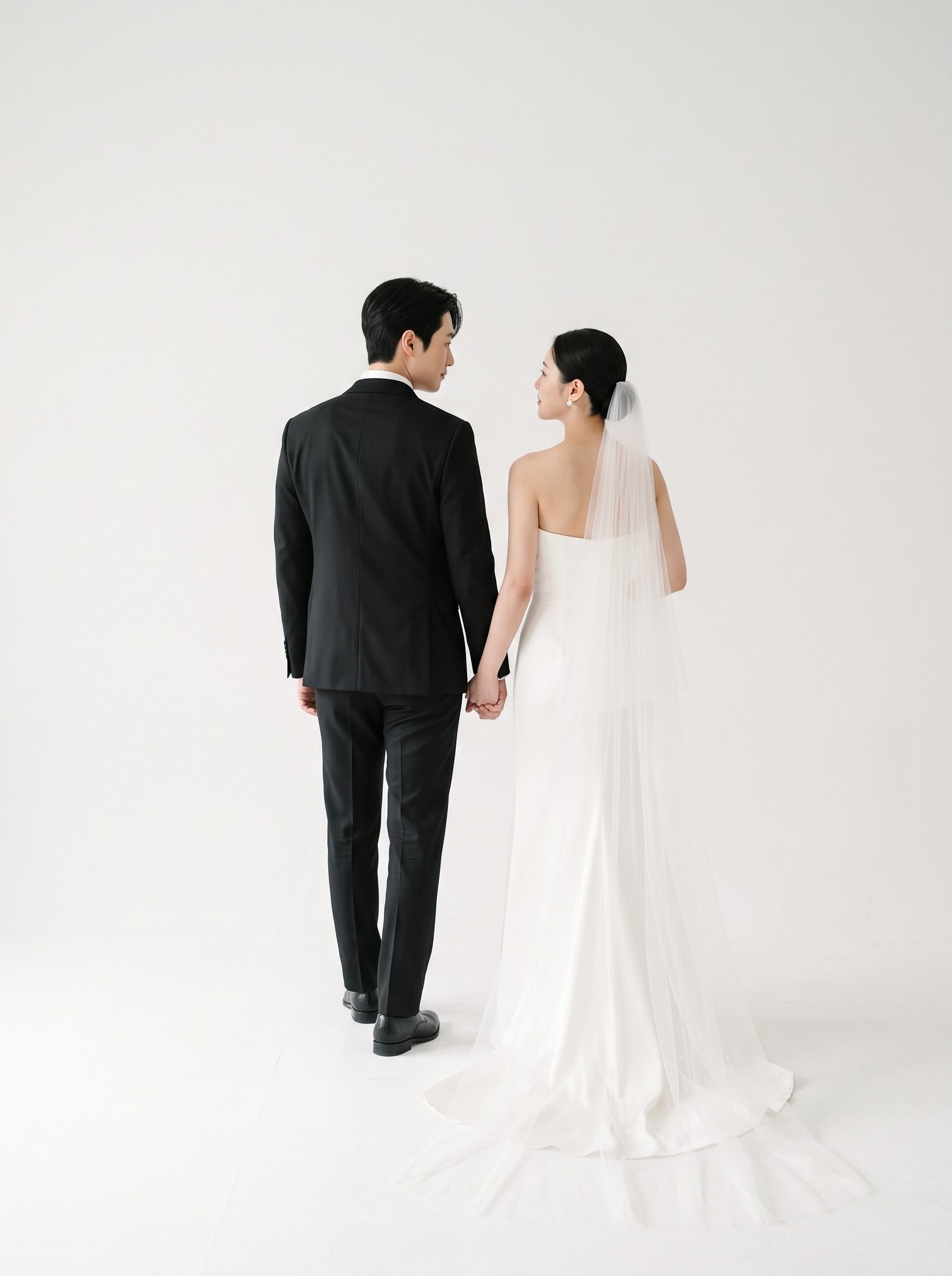 Couple walking away from camera holding hands